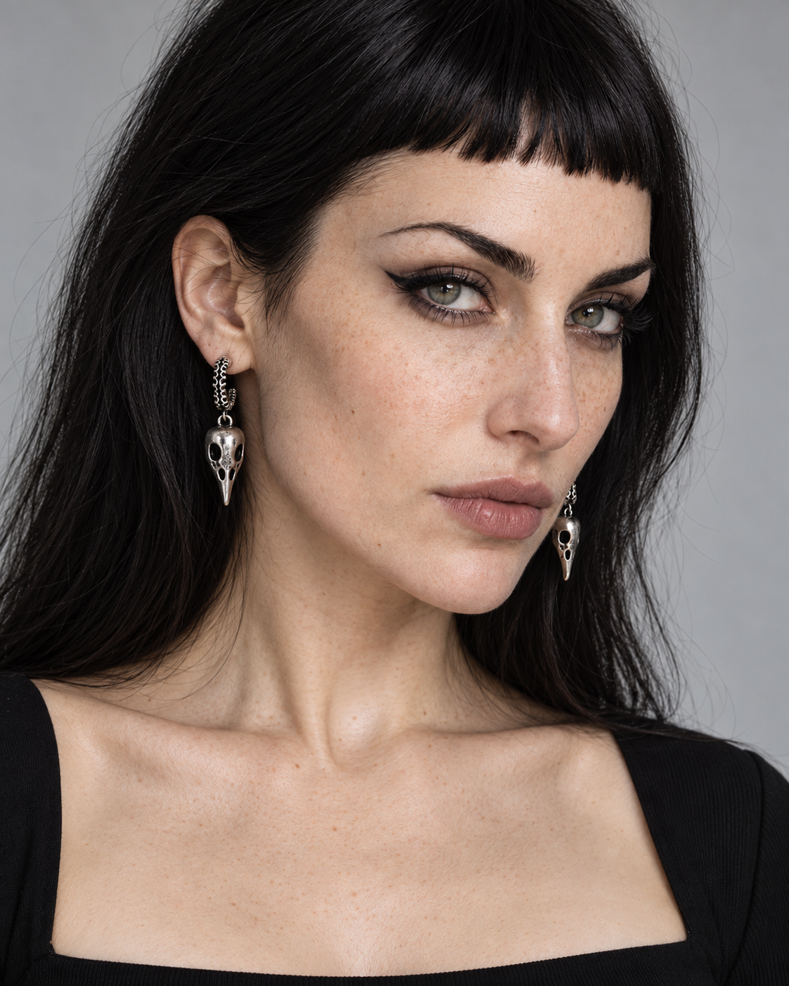 Corvus Drop Earrings — worn by an adult AI model