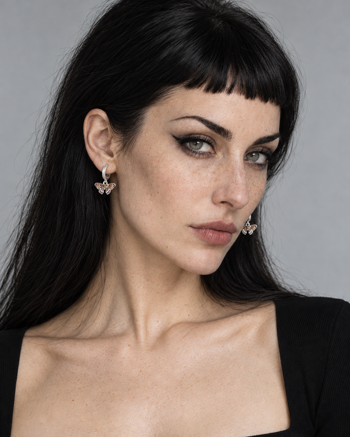 Cyrus Moth Charm Hoop Earrings — worn by an adult AI model